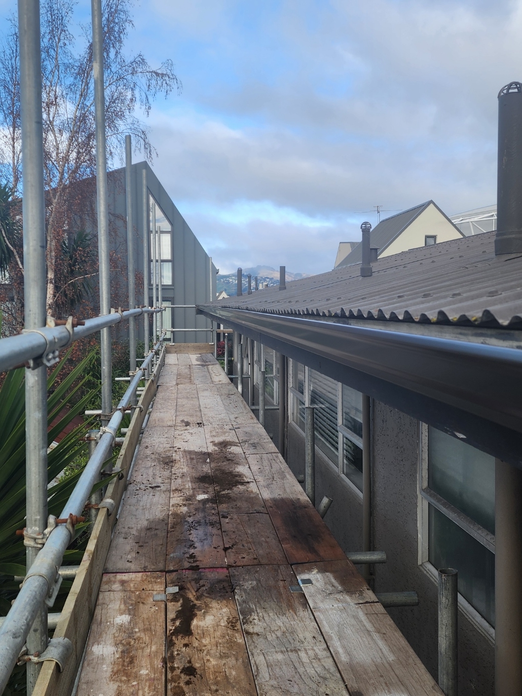 New continuous box gutter along the same Christchurch commercial roofline after Streamline replaced it