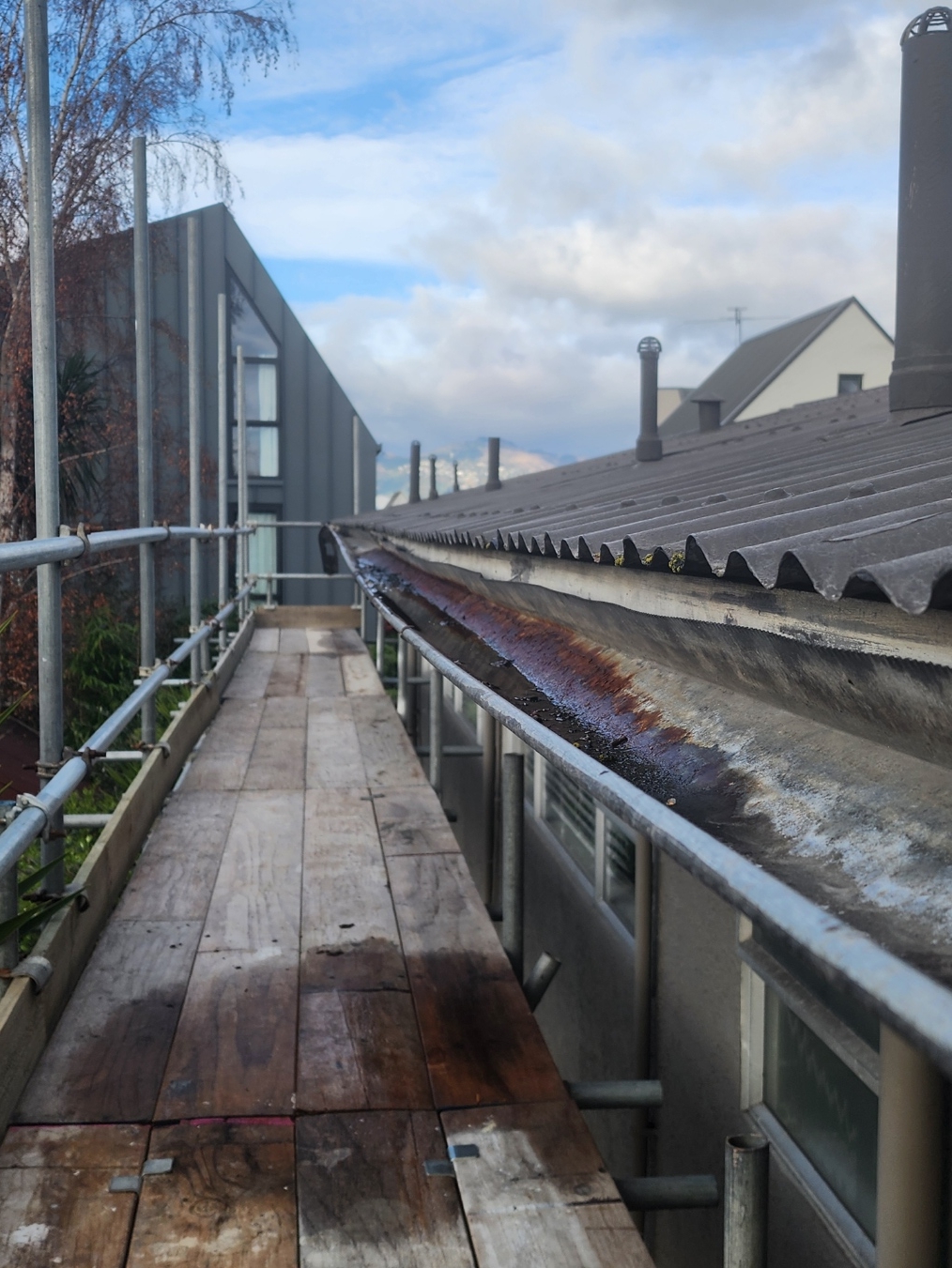 Rusted box gutter along a commercial roofline in Christchurch, before Streamline replaced it