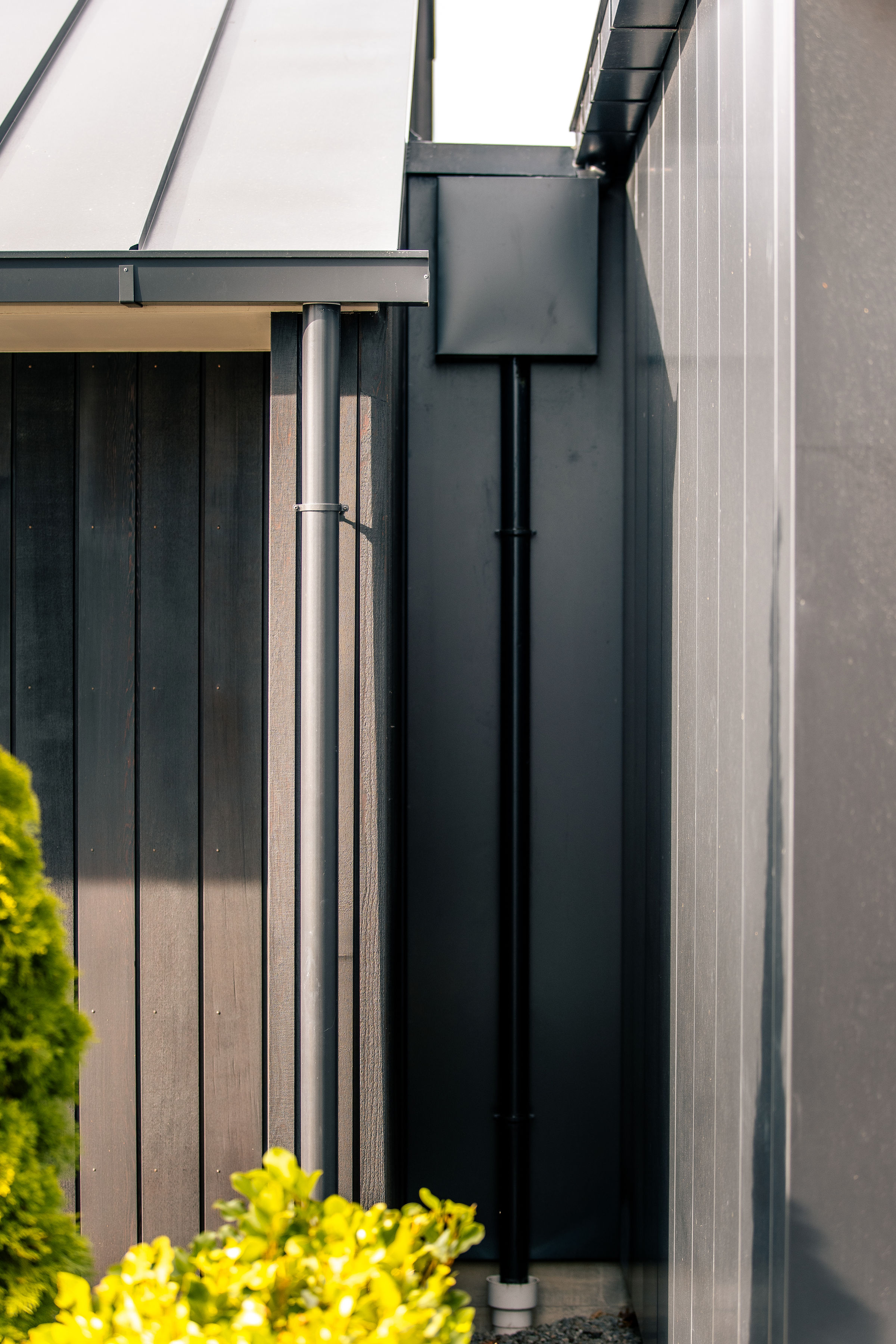80mm round Colorsteel downpipe and rainwater head in Flaxpod on a Halswell home
